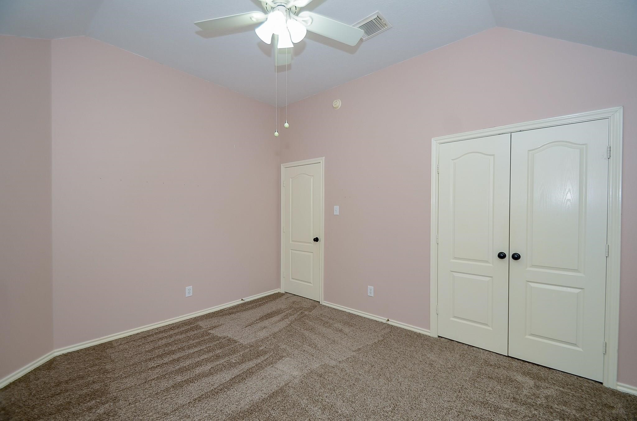 23719 Tustin Ranch Court Katy, TX 77494 - Photo 26 of 31 a view of an empty room with a chandelier fan