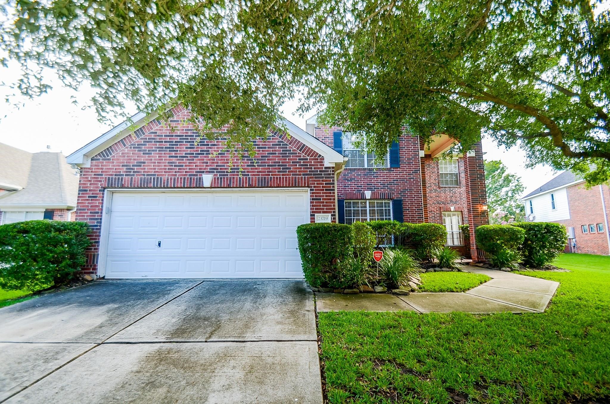 23719 Tustin Ranch Court Katy, TX 77494 - Photo 4 of 31 a front view of a house with garden