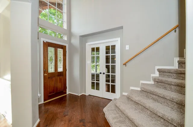 a view of entryway with wooden floor and front door