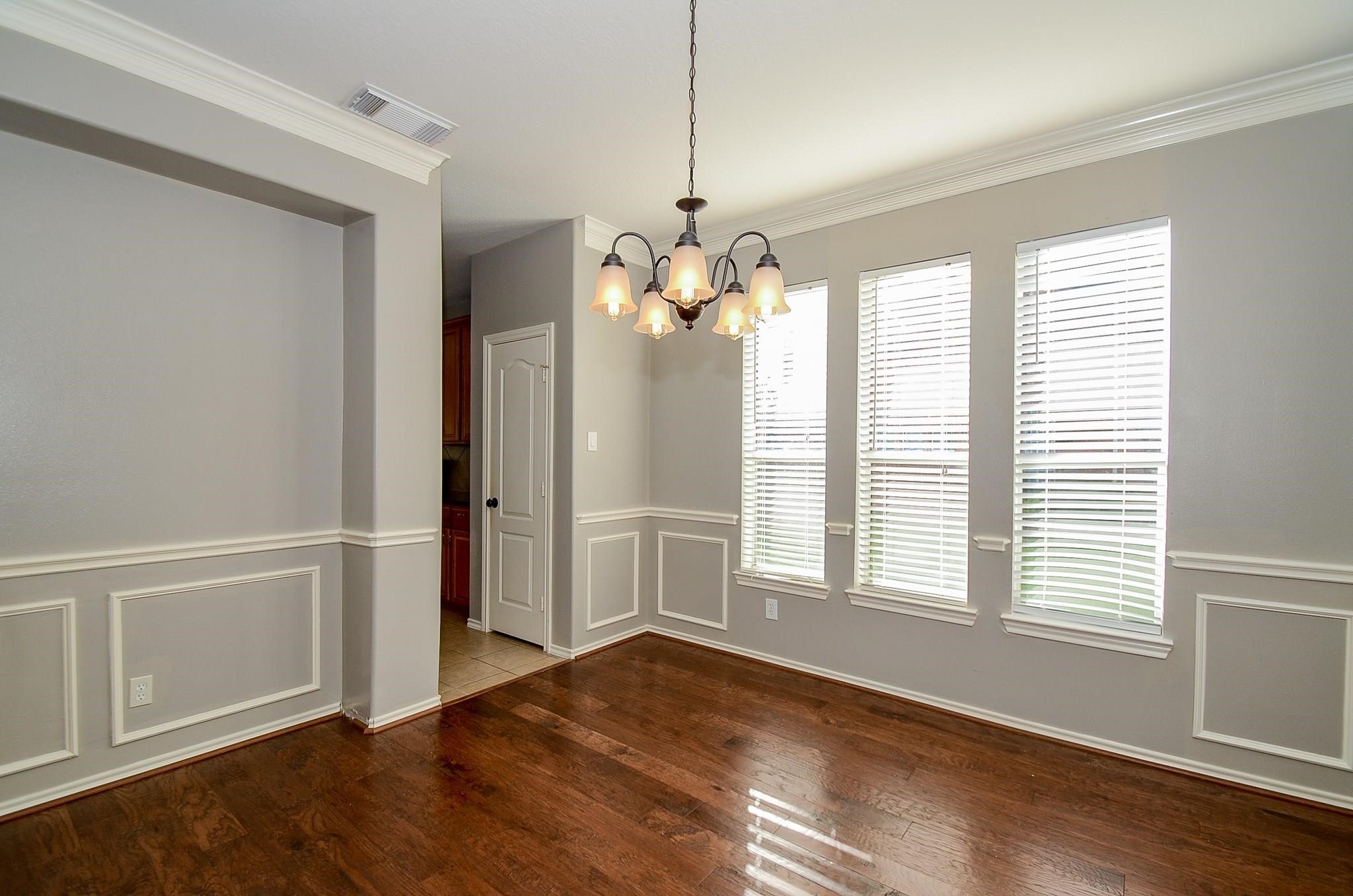 23719 Tustin Ranch Court Katy, TX 77494 - Photo 8 of 31 a view of an empty room with wooden floor and a window