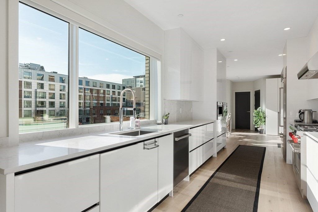 100 A Street, Unit 4 Boston, MA 02127 - Photo 2 of 42 a large white kitchen with a large window