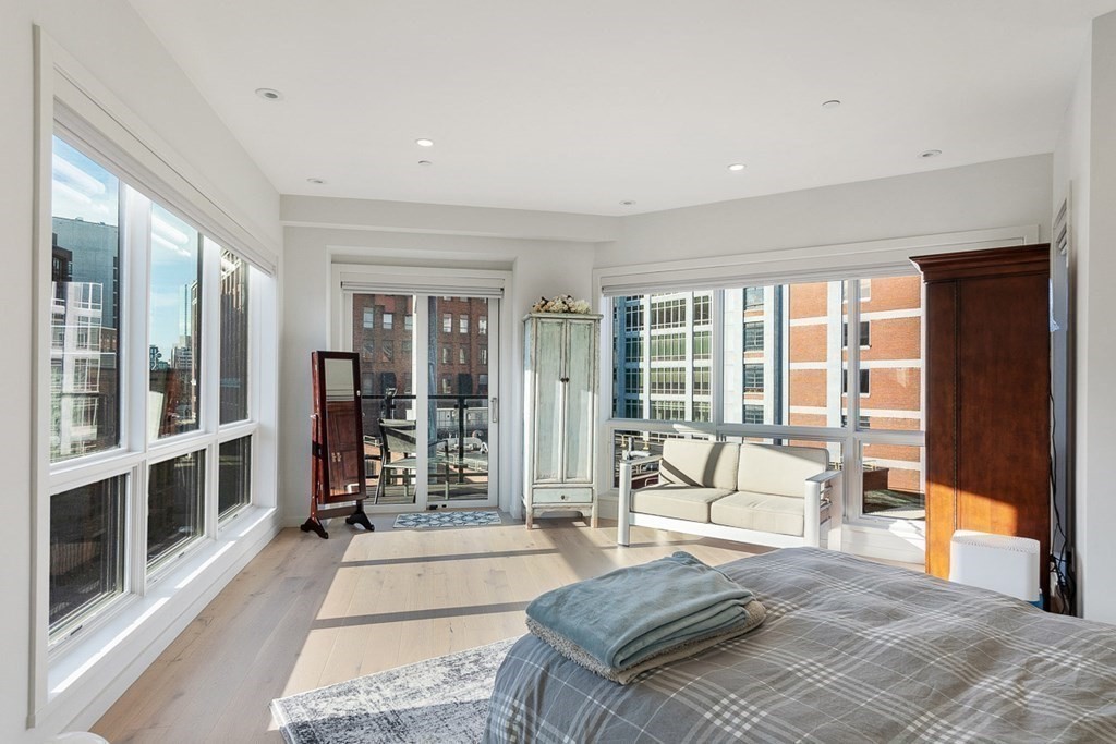 100 A Street, Unit 4 Boston, MA 02127 - Photo 23 of 42 a spacious bedroom with a large window and a couch