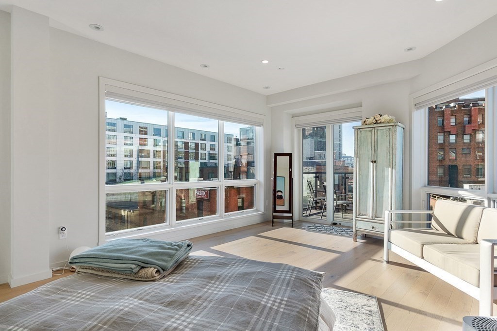 100 A Street, Unit 4 Boston, MA 02127 - Photo 25 of 42 a bedroom with a bed and glass door
