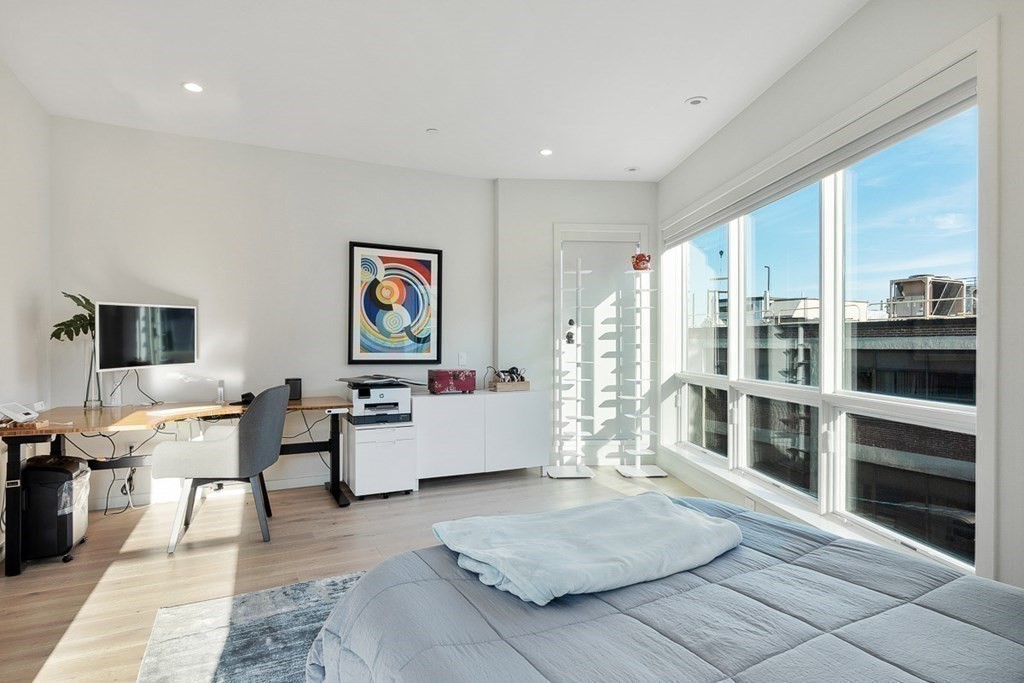 100 A Street, Unit 4 Boston, MA 02127 - Photo 28 of 42 a living room with furniture and a flat screen tv
