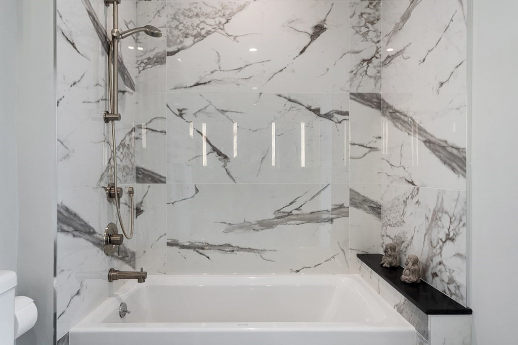 100 A Street, Unit 4 Boston, MA 02127 - Photo 31 of 42 a bathroom with a bathtub