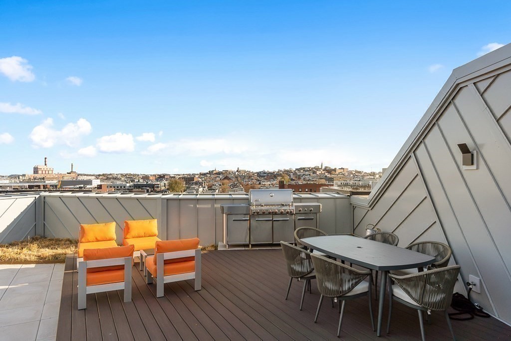 100 A Street, Unit 4 Boston, MA 02127 - Photo 34 of 42 a view of a terrace with furniture and stove