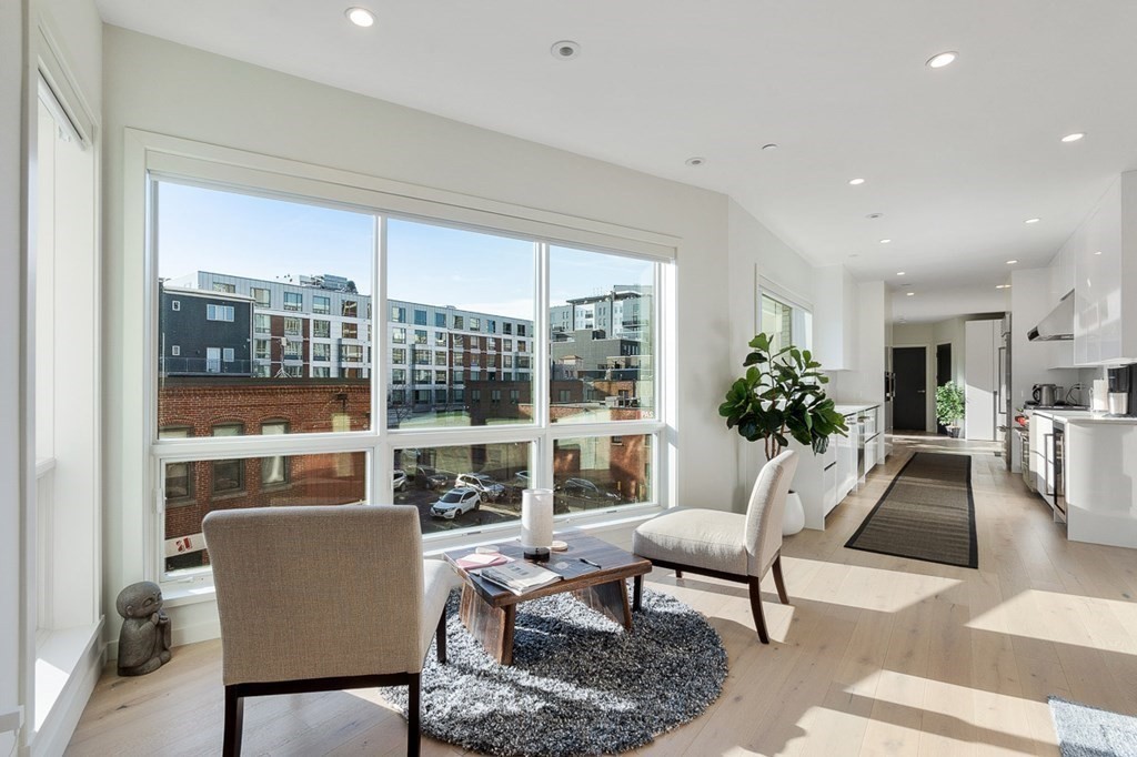 100 A Street, Unit 4 Boston, MA 02127 - Photo 7 of 42 a living room with furniture and a floor to ceiling window