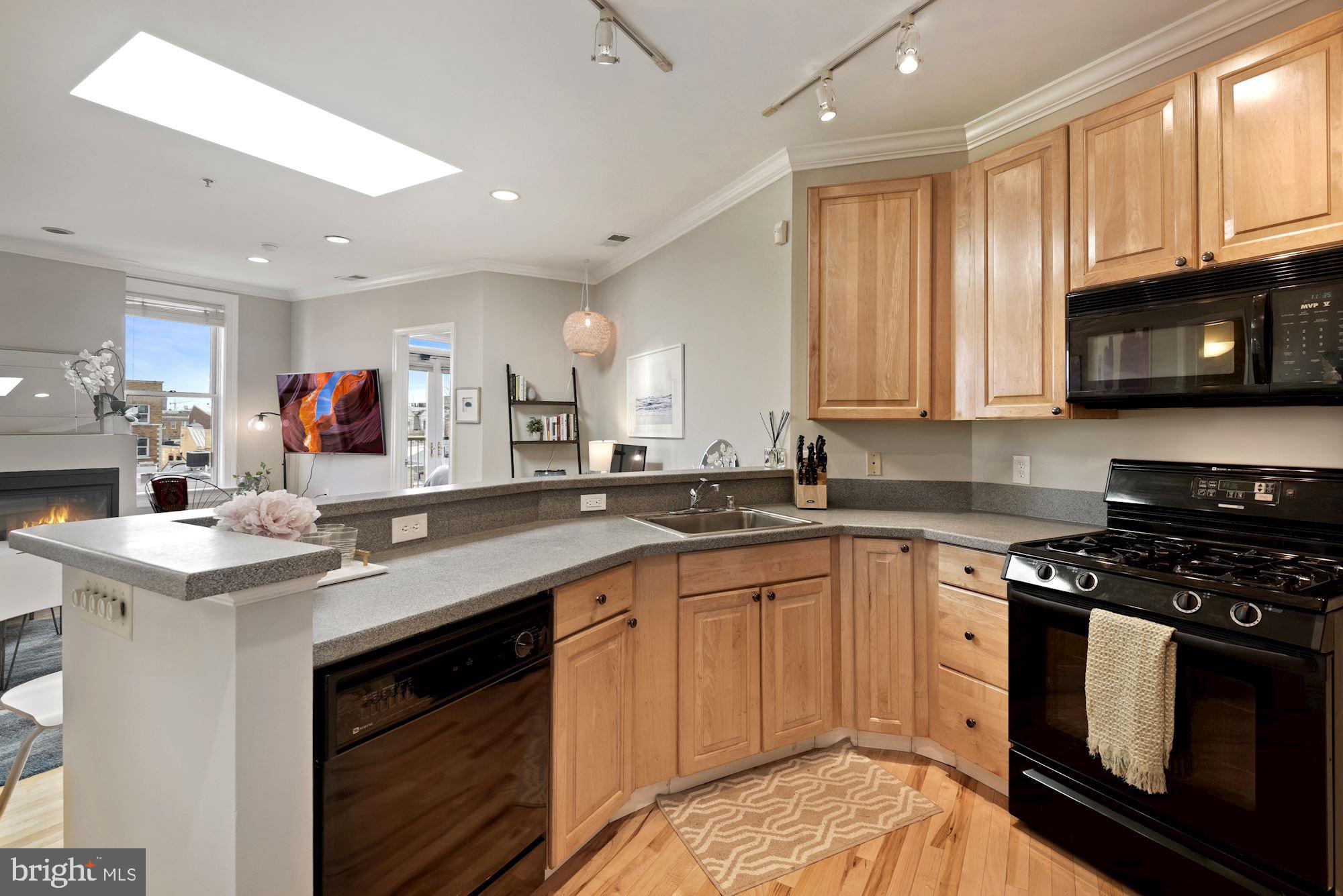 20 Logan Circle Northwest, Unit 32 Washington, DC 20005 - Photo 6 of 12 Updated kitchen overlooking living room