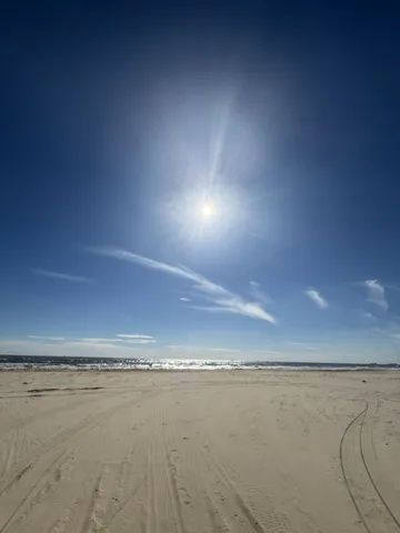 a view of a field with an ocean