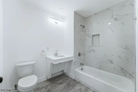a bathroom with a toilet a sink and bathtub