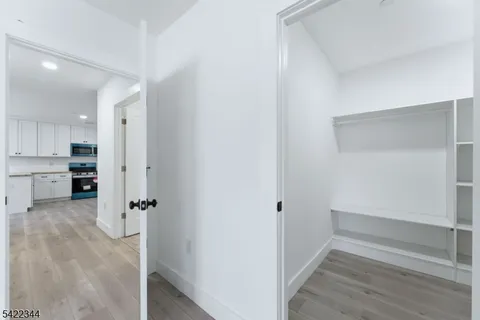 a view of a kitchen with wooden floor