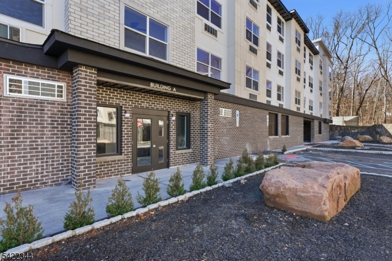 95 Shepherd Lane, Unit B302 Totowa, NJ 07512 - Photo 19 of 24 a view of a brick building with many windows