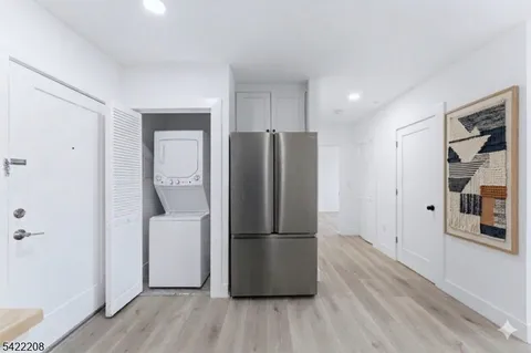 a kitchen with stainless steel appliances a refrigerator and a wooden floors
