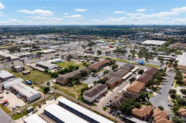 an aerial view of residential houses with city view