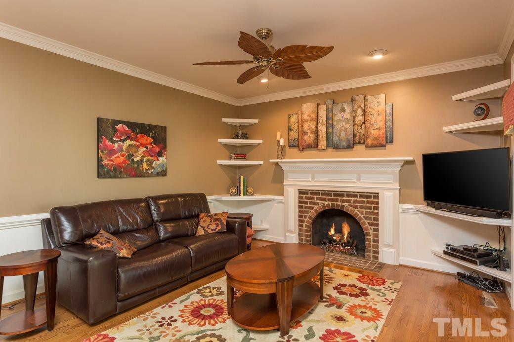 5215 Coffee Tree Drive Raleigh, NC 27613 - Photo 12 of 25 Entertaining is easy with such a large family room open to the kitchen. The brick fireplace keeps the room warm and cozy.