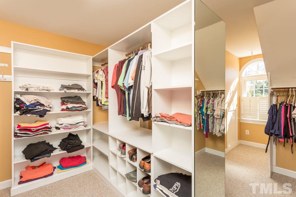 5215 Coffee Tree Drive Raleigh, NC 27613 - Photo 10 of 25 Incredible walk-in closet you’ve got to see to believe! Shelving, cubbies, hanging bars and lots of lighting are a fashionistas dream! A secret reading nook is accessed through the master walk-in closet!