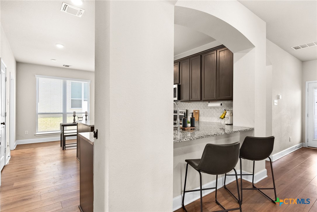 5712 Redfish Court Belton, TX 76513 - Photo 14 of 37 a view of kitchen with cabinets and wooden floor
