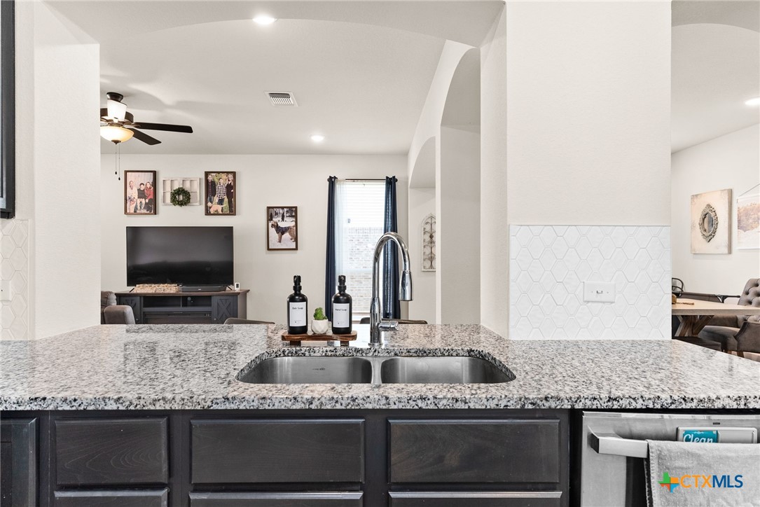 5712 Redfish Court Belton, TX 76513 - Photo 17 of 37 a bathroom with double vanity sinks granite granite and a mirror