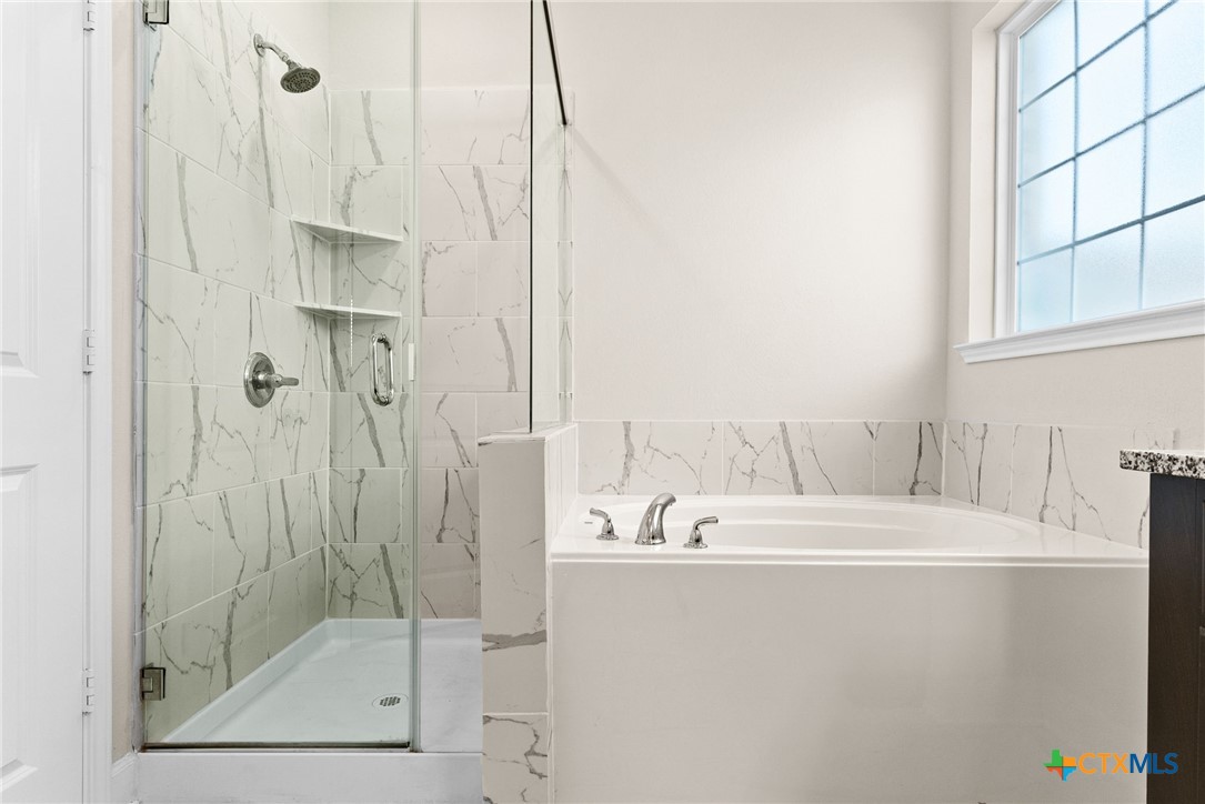 5712 Redfish Court Belton, TX 76513 - Photo 23 of 37 a bathroom with a bathtub and a shower