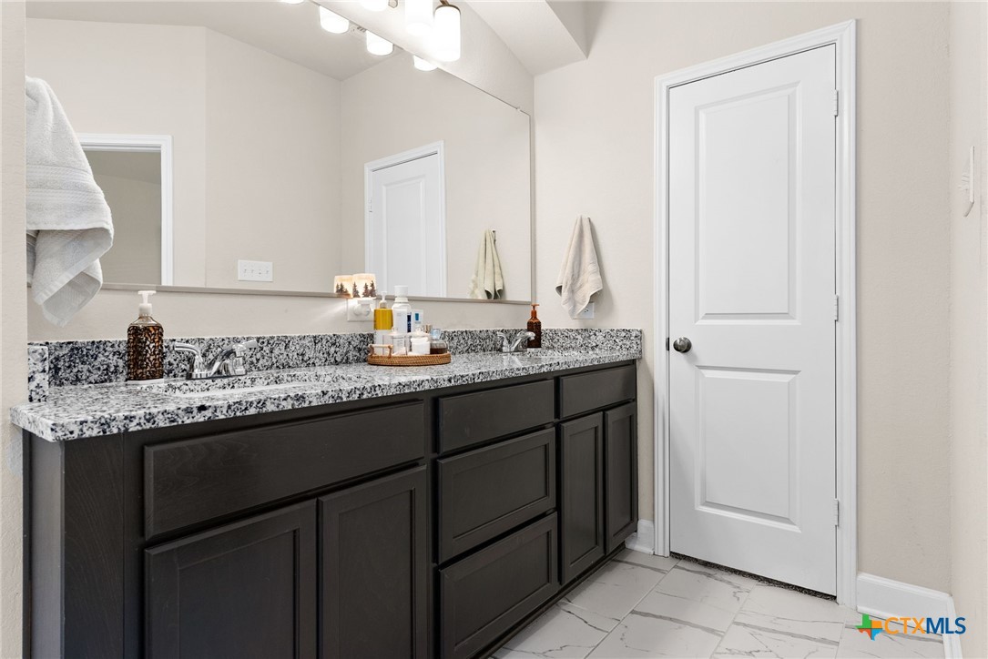 5712 Redfish Court Belton, TX 76513 - Photo 24 of 37 a bathroom with a sink and a mirror