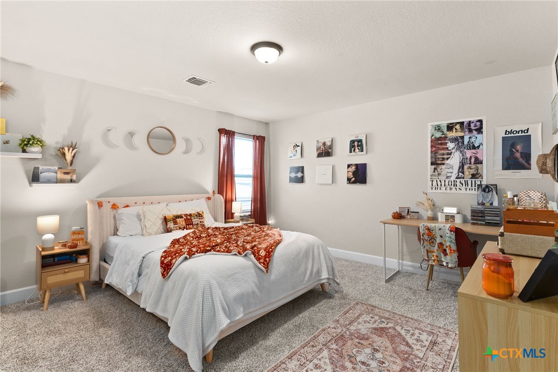 5712 Redfish Court Belton, TX 76513 - Photo 25 of 37 a bedroom with a bed and wooden floor