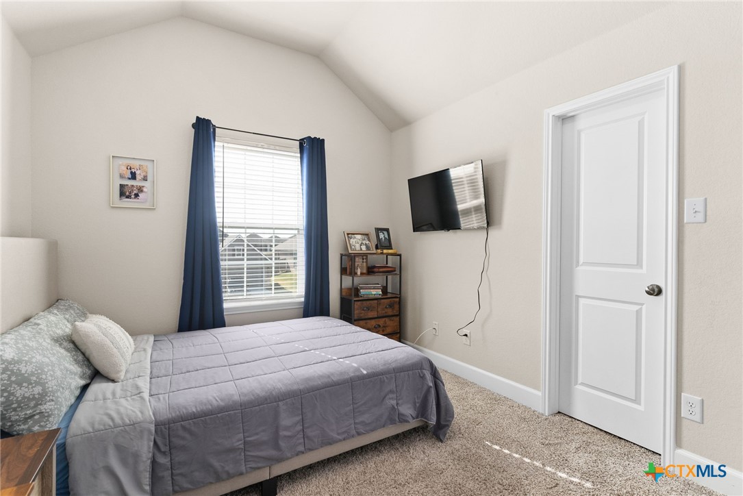 5712 Redfish Court Belton, TX 76513 - Photo 9 of 37 a bedroom with a bed and a flat screen tv