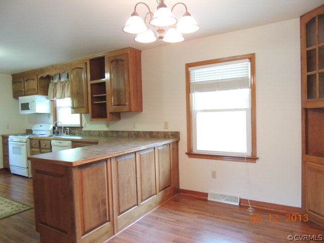 580 Guinea Road Farmville, VA 23901 - Photo 6 of 16 a kitchen with a sink cabinets and wooden floor