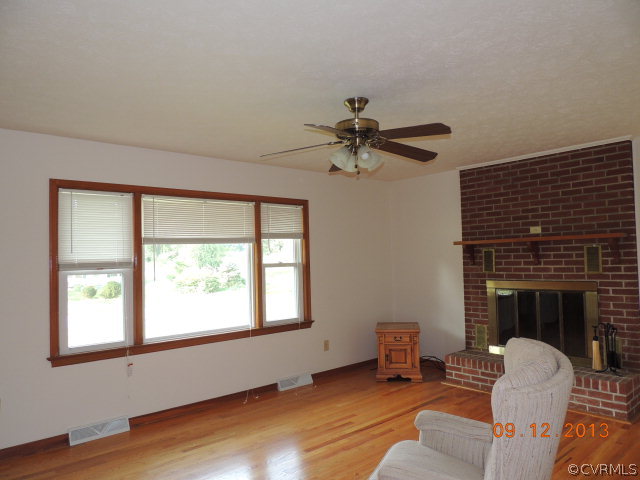 580 Guinea Road Farmville, VA 23901 - Photo 8 of 16 a living room with furniture and a fireplace
