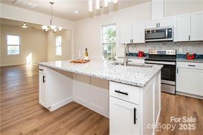 115 West Lacy Street Chester, SC 29706 - Photo 14 of 47 a kitchen with stainless steel appliances granite countertop a sink stove and refrigerator