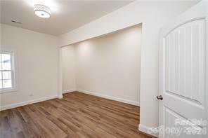 115 West Lacy Street Chester, SC 29706 - Photo 15 of 47 an empty room with wooden floor and windows