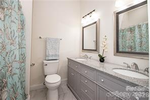 115 West Lacy Street Chester, SC 29706 - Photo 18 of 47 a bathroom with a granite countertop sink toilet mirror and shower
