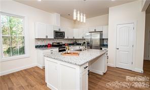 115 West Lacy Street Chester, SC 29706 - Photo 2 of 47 a kitchen with stainless steel appliances granite countertop a sink stove and refrigerator