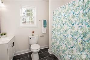 115 West Lacy Street Chester, SC 29706 - Photo 22 of 47 a white toilet sitting next to a shower curtain