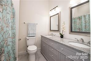 115 West Lacy Street Chester, SC 29706 - Photo 23 of 47 a bathroom with a granite countertop sink toilet mirror and shower