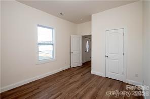 115 West Lacy Street Chester, SC 29706 - Photo 25 of 47 an empty room with wooden floor and windows