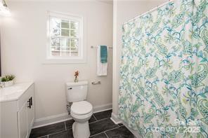 115 West Lacy Street Chester, SC 29706 - Photo 27 of 47 a white toilet sitting next to a shower curtain