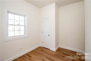 115 West Lacy Street Chester, SC 29706 - Photo 30 of 47 an empty room with wooden floor and windows