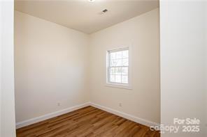 115 West Lacy Street Chester, SC 29706 - Photo 33 of 47 a view of an empty room with wooden floor and a window