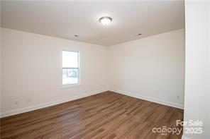 115 West Lacy Street Chester, SC 29706 - Photo 38 of 47 an empty room with wooden floor and windows