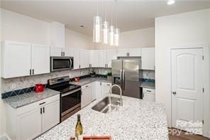 115 West Lacy Street Chester, SC 29706 - Photo 7 of 47 a kitchen with granite countertop a refrigerator stove and sink