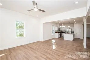 a view of kitchen with kitchen island stainless steel appliances refrigerator stove microwave and cabinets
