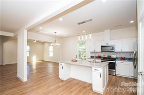 115 West Lacy Street Chester, SC 29706 - Photo 9 of 47 a kitchen with stainless steel appliances kitchen island granite countertop a sink and cabinets
