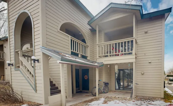 a view of a house with a balcony and front door