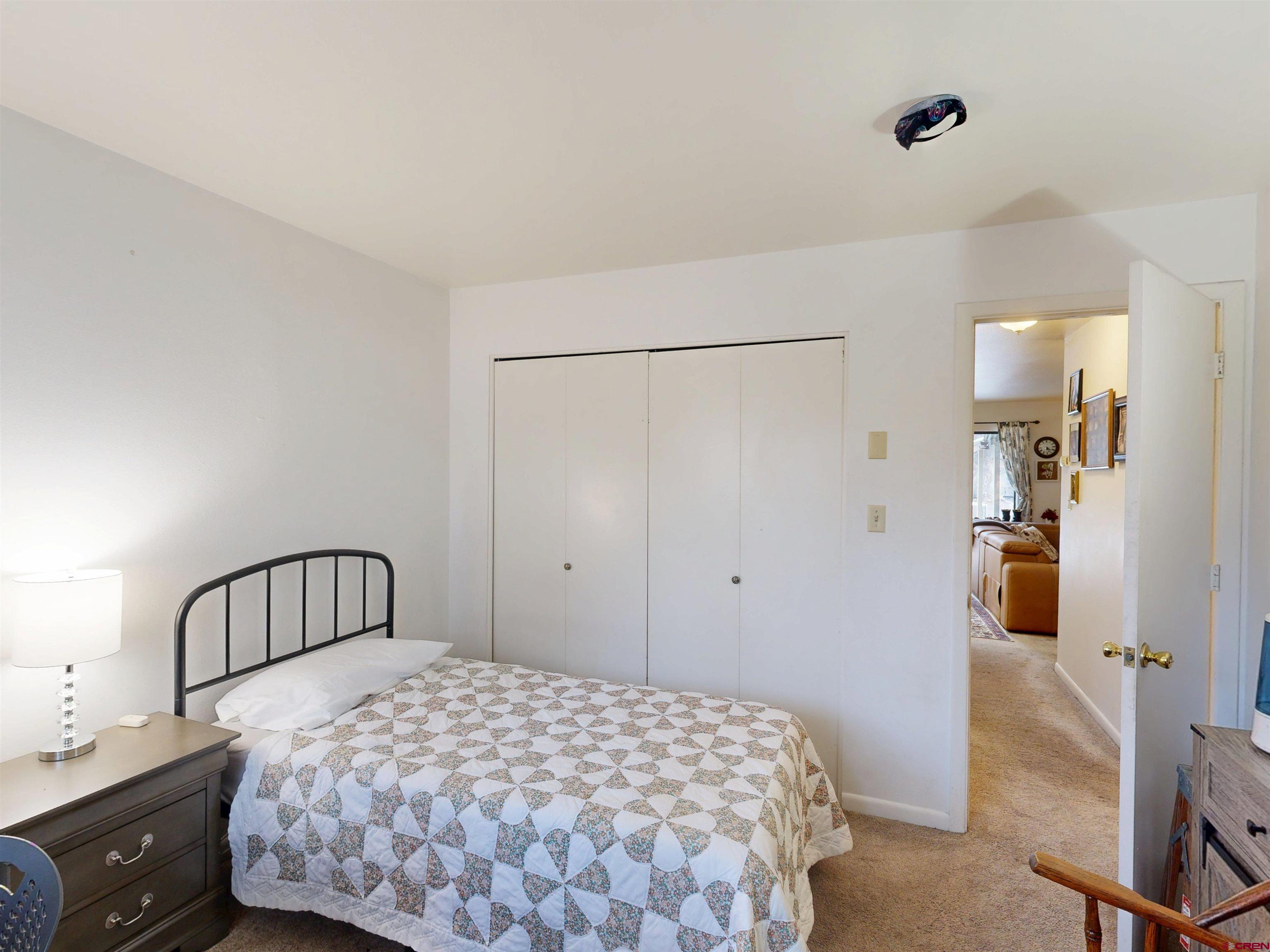 1200 Florida Road, Unit 17 Durango, CO 81301 - Photo 14 of 23 a bedroom with a bed and a chandelier