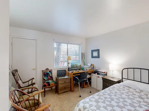 a room with furniture a air conditioner and windows