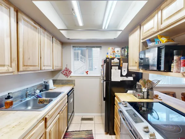 a kitchen with stainless steel appliances granite countertop a sink stove and cabinets