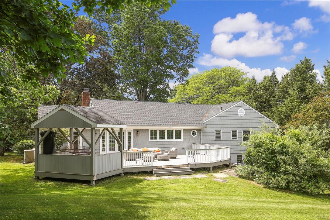 a front view of a house with swimming pool having outdoor seating