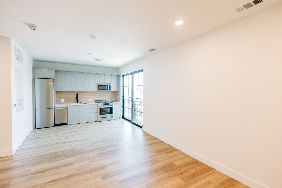 4315 South Congress Avenue, Unit 406 Austin, TX 78745 - Photo 6 of 19 a view of a kitchen with wooden floor