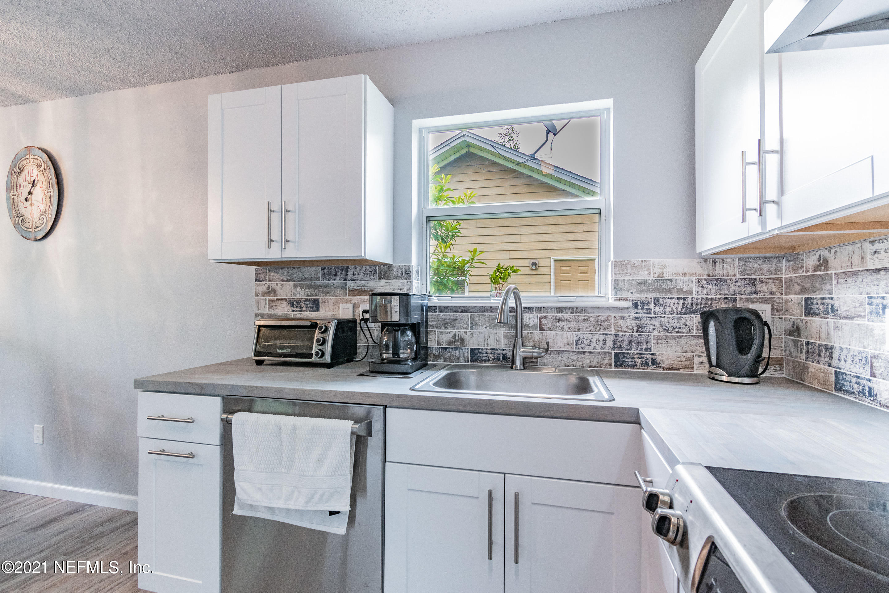 2154 Brooklyn Road Jacksonville, FL 32209 - Photo 11 of 37 a kitchen with kitchen island granite countertop a sink a stove and cabinets