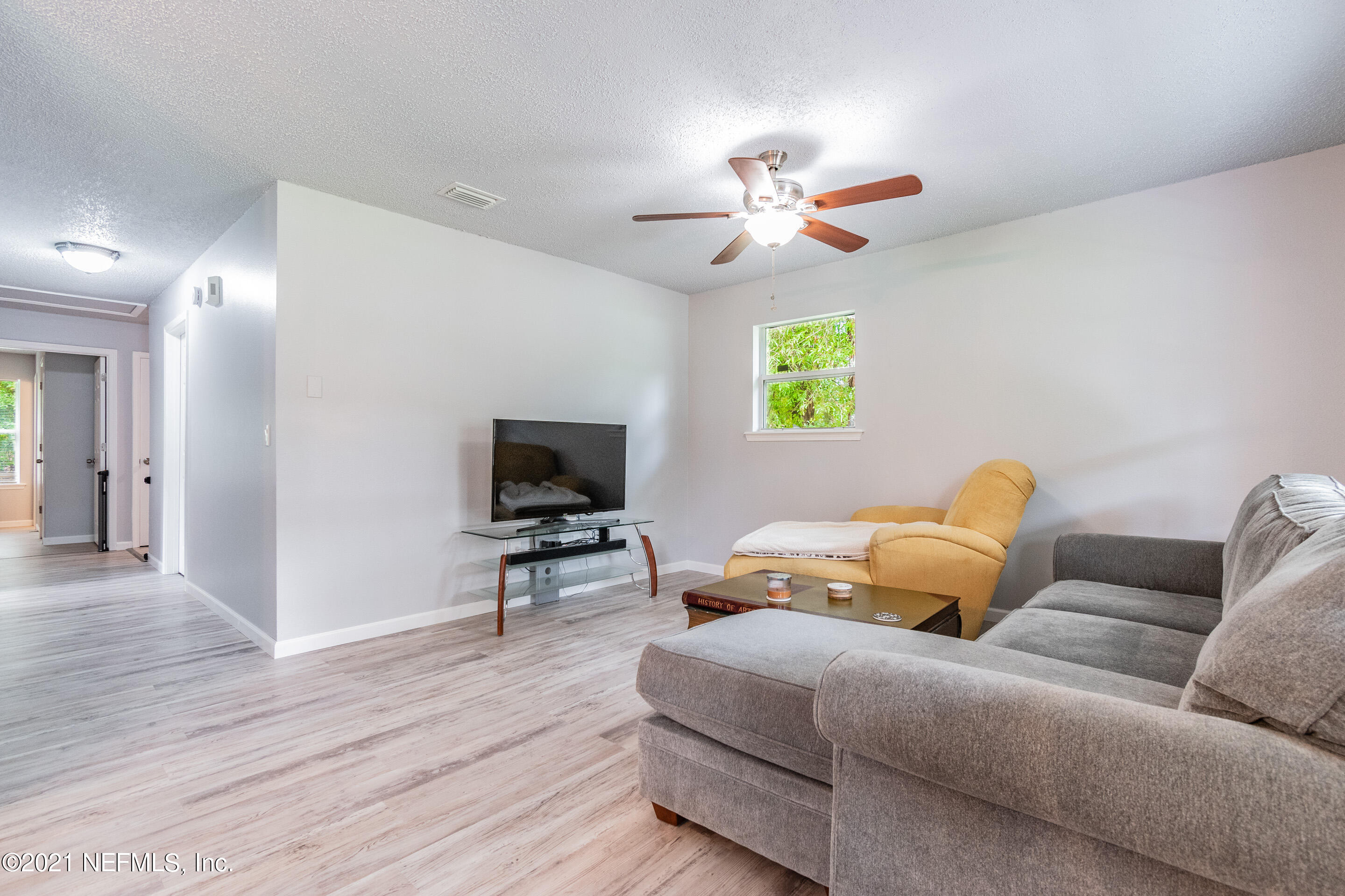 2154 Brooklyn Road Jacksonville, FL 32209 - Photo 6 of 37 a living room with furniture a window and a flat screen tv